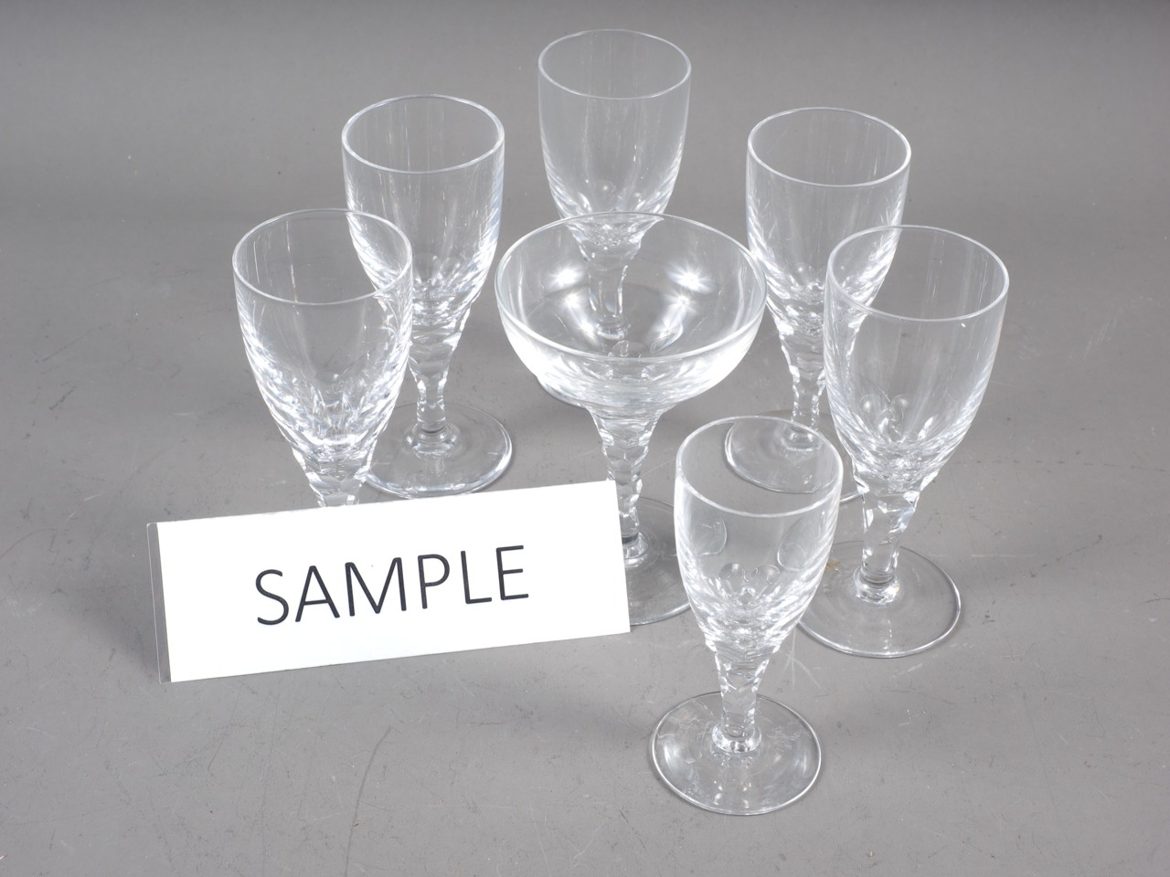 A set of seventeen port glasses with faceted stems and two matching glasses