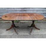 A late 19th century mahogany double pedestal dining table, on vase turned columns and tripod splay