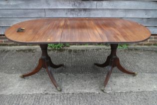 A late 19th century mahogany double pedestal dining table, on vase turned columns and tripod splay