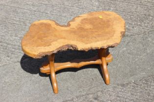 A modern burr maple slice top occasional table, on panel end supports, 23" wide x 12" high and a