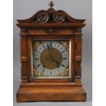 An Edwardian carved walnut cased mantel clock with brass dial and eight-day striking movement 15"