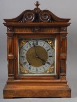 An Edwardian carved walnut cased mantel clock with brass dial and eight-day striking movement 15"
