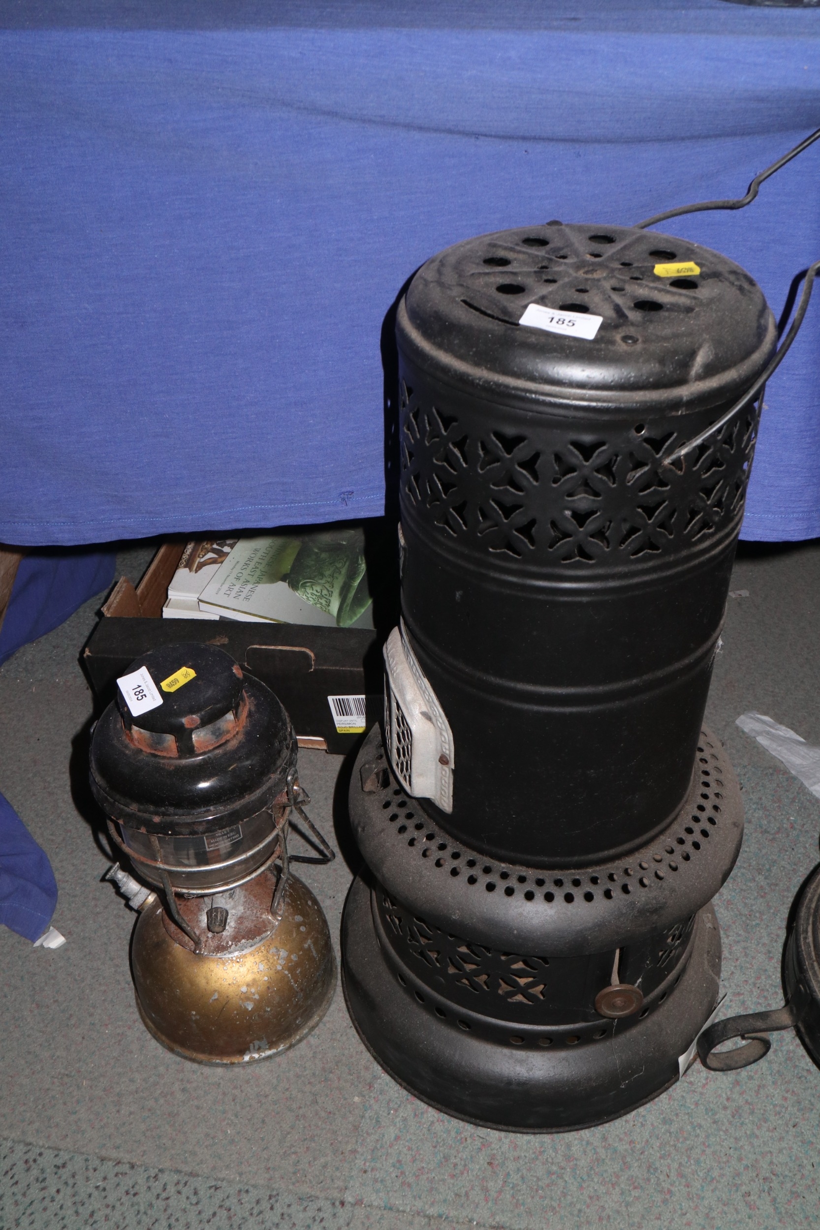A Valor black metal room heater with pierced decoration, 24" high, and a smaller burner, 13 1/2"