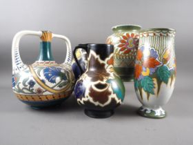 An early 20th century Gouda two-handled vase, a similar jug and three other Gouda vases, tallest 10"