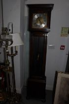 A 1930's oak long case clock with eight-day striking and chiming movement and glazed panelled