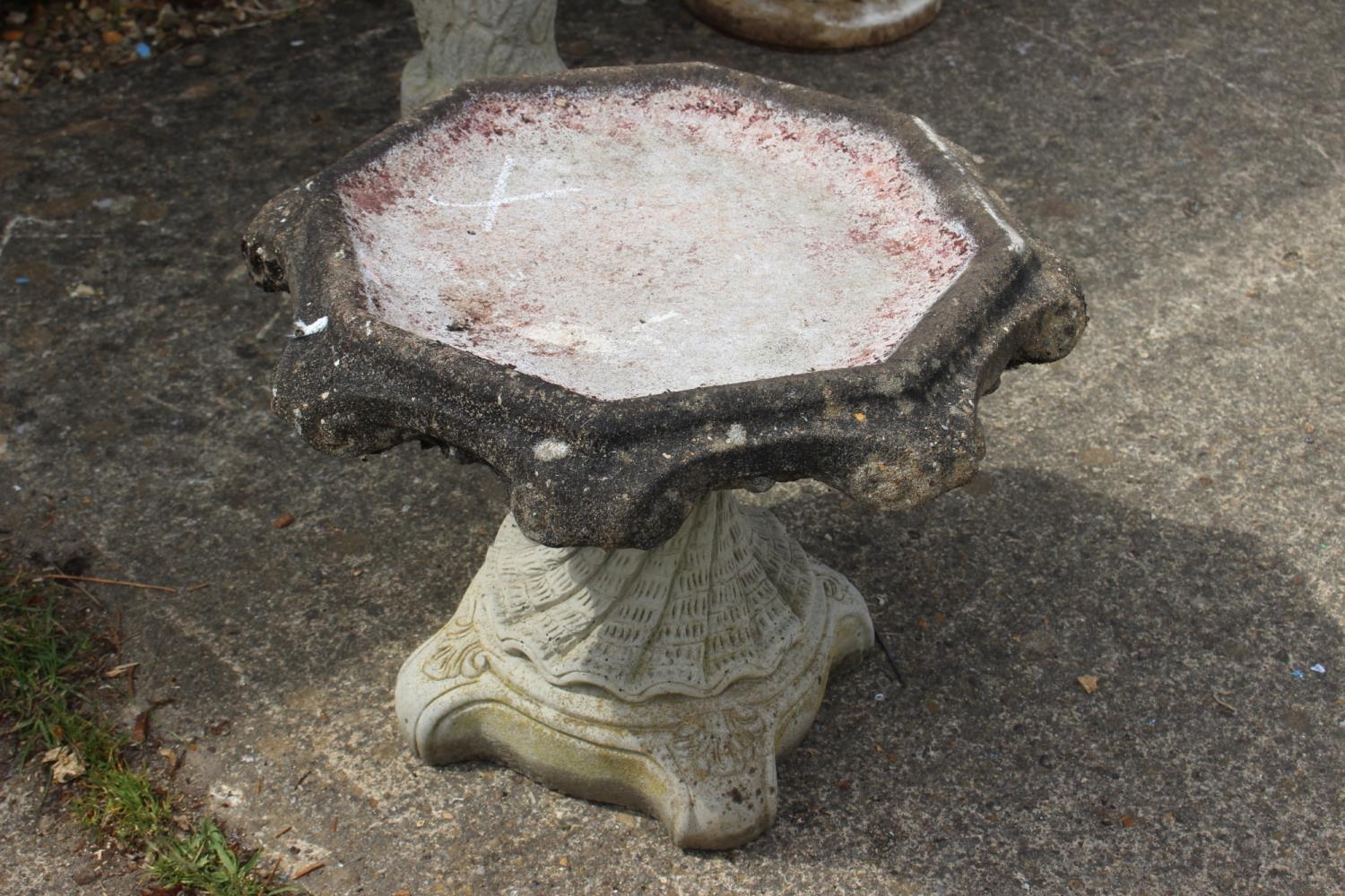 A cast stone octagonal bird bath, on spiral twist stand, 21" wide x 16" high