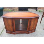 A figured mahogany shape front corner cabinet, fitted central glazed door and two cupboards, 46" x