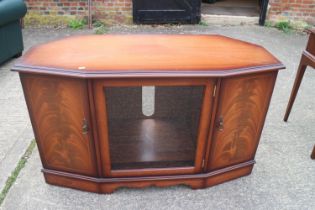 A figured mahogany shape front corner cabinet, fitted central glazed door and two cupboards, 46" x