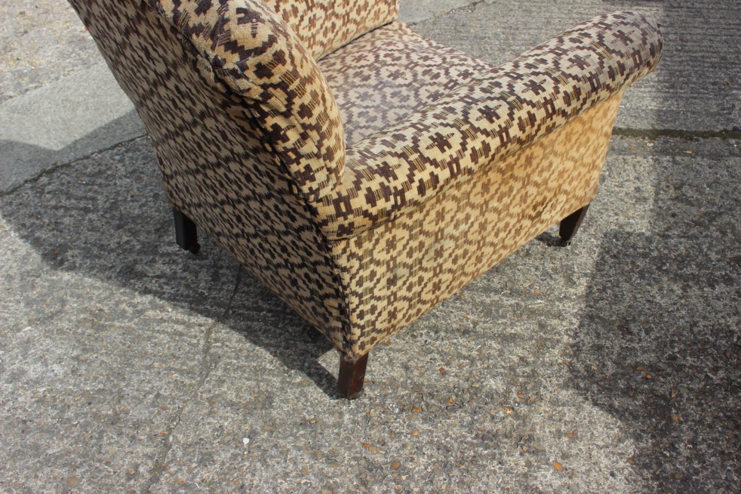 An Edwardian low seat armchair, upholstered in a geometric fabric, on square taper supports - Image 2 of 2
