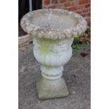 A cast stone campana planter with floral decoration, 19" dia x 26" high