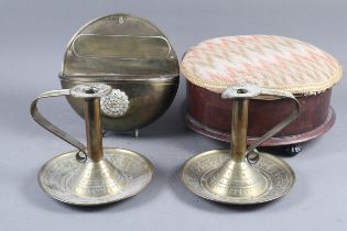 A pair of brass chamber sticks with engraved decoration, 6 1/2" high, a similar wall planter, a
