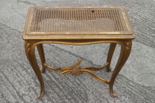 A carved giltwood stool with cane panel seat, on cabriole supports (stretcher for repair), an
