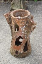A 19th century terracotta "tree trunk" strawberry planter, 24 1/2" high (damages)