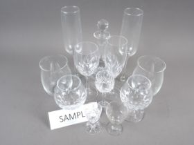 A quantity of glassware, including tumblers, champagne flutes, brandy balloons and other table glass