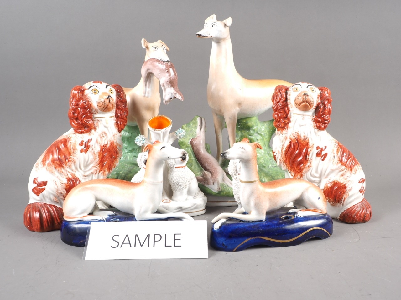 A quantity of 19th century and later Staffordshire models, including spaniels, greyhounds, etc (some