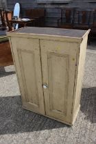 A cream painted pine cupboard enclosed two doors with four shelves, 28 1/2" wide x 41 3/4" high