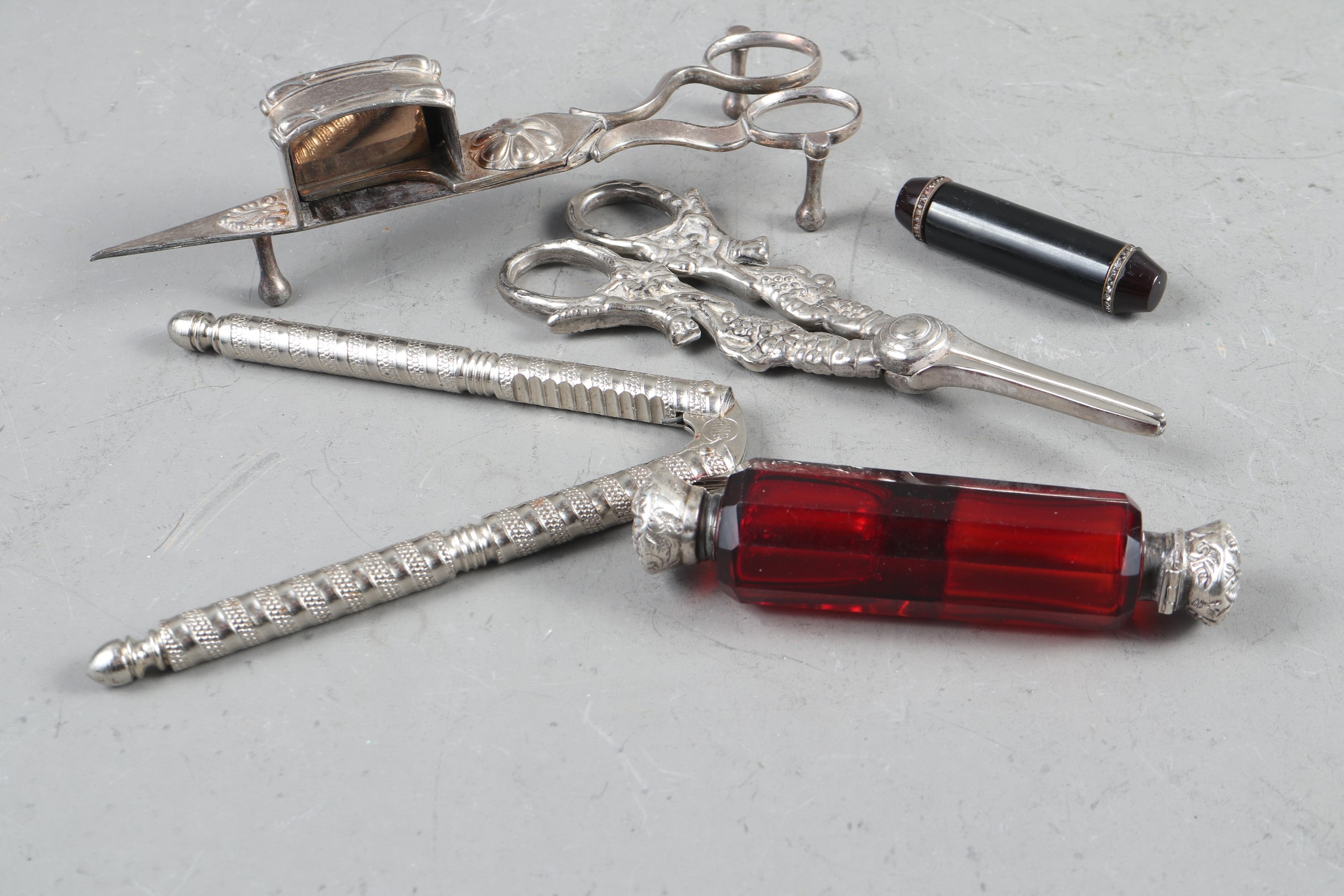 A Victorian white metal and ruby glass double-ended scent bottle, a pair of silver plated grape