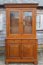 A cherrywood bookcase, the upper section enclosed two glazed panelled doors over two drawers and