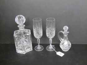 A pair of Edinburgh crystal champagne flutes together with a cut glass decanter and a cut glass