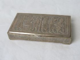 A Persian white metal cigarette box chased and engraved with a depiction of Nebuchadnezzar and a