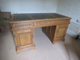 A light oak Victorian style kneehole pedastle desk,