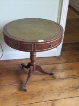 A reproduction leather top drum side table, raised over tripod base, 50cm dia.