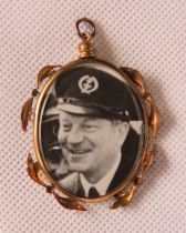 A vintage double sided glazed pendant with military themed photographs within.