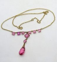 An early 20th century pink paste stone necklace, stamped 9ct to the clasp,
