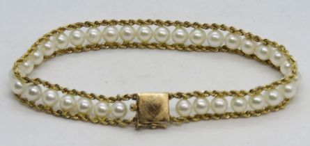 A 14ct gold and pearl bracelet measuring 18cm in length, 11.