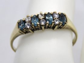 A 9ct gold and aquamarine ring, the four oval cut stones separated by three pairs of white stones,