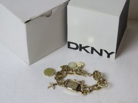 A ladies DKNY charm bracelet style wrist watch in original packaging numbered 11005 NY-4831