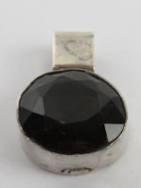 A faceted smoky quartz pendant, white metal, no apparent hallmarks, approx 1.9cm dia.