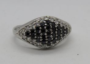 A silver cocktail ring encrusted with white and black cz stones, stamped 925, size S.