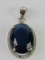 A blue stone pendant stamped 925, 2.8cm in length.