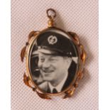 A vintage double sided glazed pendant with military themed photographs within.