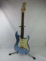 A Fender Squier Stratocaster guitar in pale blue, stand not included.