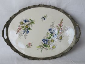 A floral ceramic serving tray with white metal gallery having twin end handles.