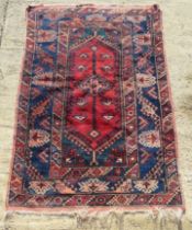 A red and blue ground geometric pattern Oriental rug measuring approx 123 x 179cm.