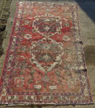 A large red ground geometric pattern oriental rug measuring approx 190 x 295cm.