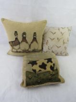 Three farmhouse themed cushions, ducks, pheasants and cow.