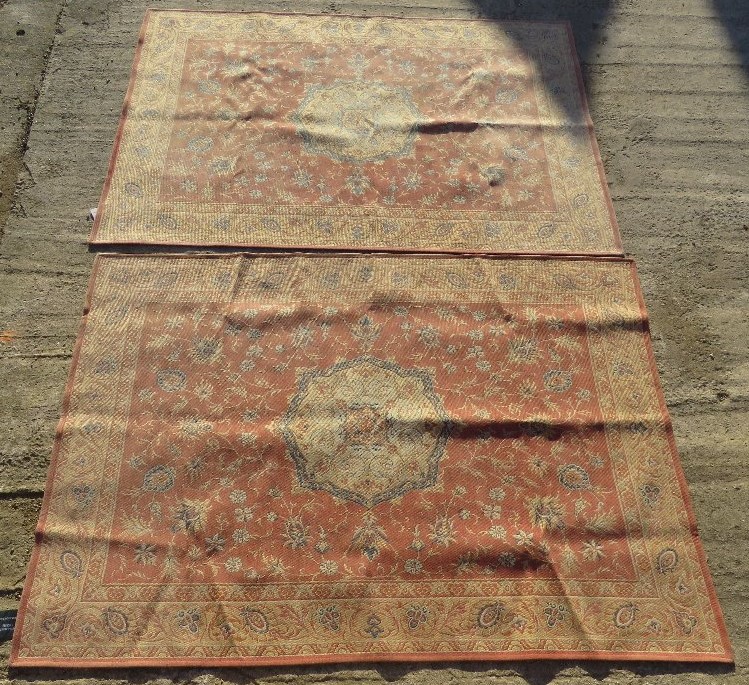 A pair of terracotta ground floral pattern Laura Ashley rugs, each measuring approx 135 x 195cm.