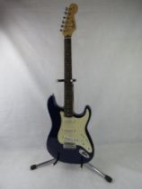 A Fender Squier Stratocaster guitar in dark blue, stand not included.