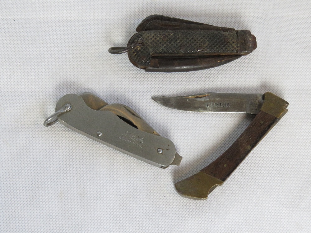 Three pocket knives including an army boot jack knife, a 1981 knife with broad arrow upon,