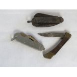 Three pocket knives including an army boot jack knife, a 1981 knife with broad arrow upon,