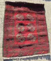 A red ground geometric pattern Oriental rug measuring approx 82 x 107cm.