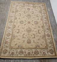 A large cream ground 100% wool rug,