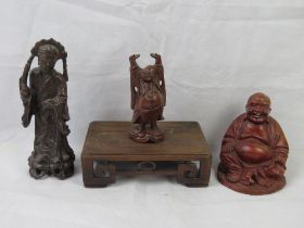 An Oriental hardwood carved stand together with three figures including Buddha. Four items.