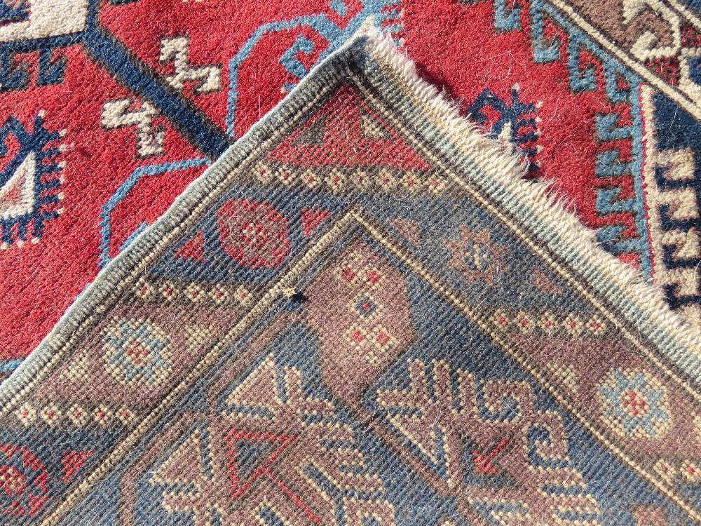 A red and blue ground geometric pattern Oriental rug measuring approx 120 x x195cm. - Image 2 of 3