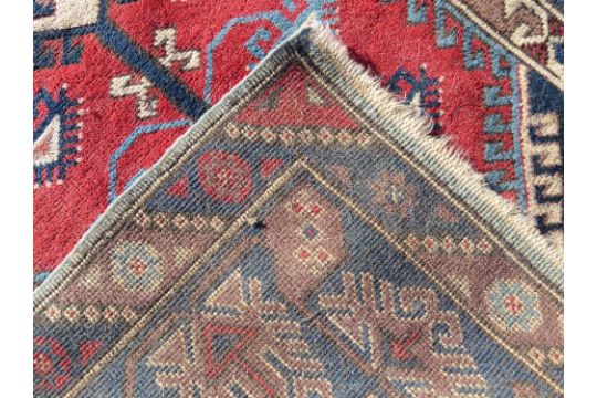 A red and blue ground geometric pattern Oriental rug measuring approx 120 x x195cm. - Image 2 of 3