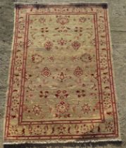 A cream and red ground floral pattern rug measuring approx 124 x 171cm.